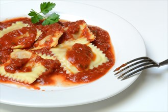 Ravioli with tomato sauce on plate with fork