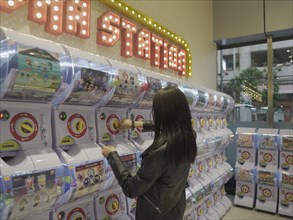 Girl at toy vending machine in Macau