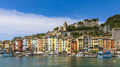 Pastel-coloured house facades in the harbour of Portovenere