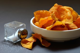 Sweet crisps in skin and salt container