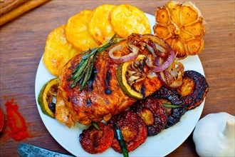 Roasted grilled BBQ chicken breast with herbs and spices rustic style