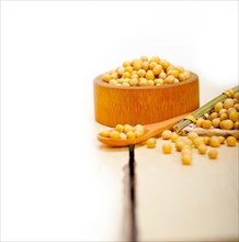 Organic soya beans over rustic wood table macro closeup