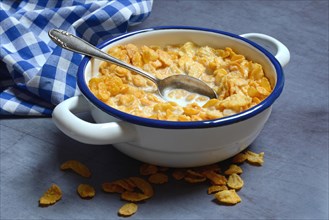 Cornflakes with milk in bowl