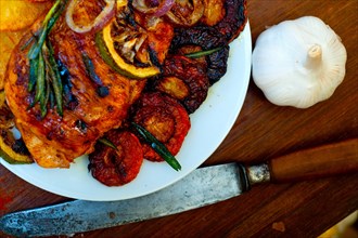 Roasted grilled BBQ chicken breast with herbs and spices rustic style