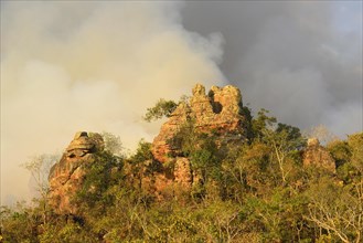 Bizarre rock formation and smoke cloud during a bushfire