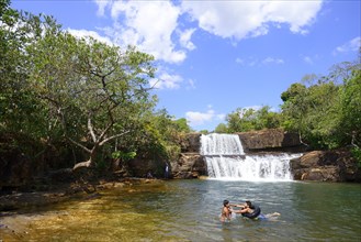 Children with swimming hoops at the waterfall Cachoeira da Martinha