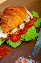 Savory croissant brioche bread with chicken breast and vegetable rustic style