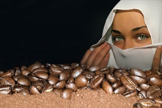 Coffee beans of the Arabica variety lie on ground coffee