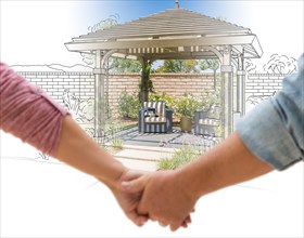 A couple hold his hands looking at design and photo of new yard pergola