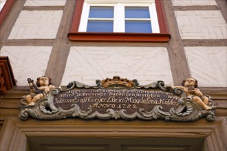 Baroque cartouche with putto above old wooden door