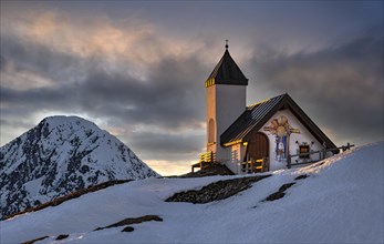 Alpine chapel of the Astenau-Alm at sunset