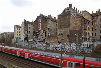 The Deutsche Bahn airport express train passes the old buildings on Kopenhagener Strasse on its way to BER airport