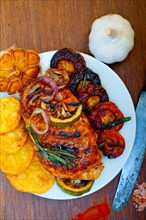 Roasted grilled BBQ chicken breast with herbs and spices rustic style