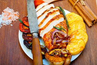 Roasted grilled BBQ chicken breast with herbs and spices rustic style