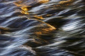 Flowing water with light reflections