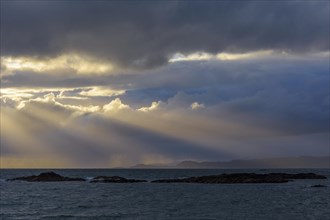 Scottish coast at sunset with sunrays