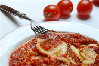 Ravioli with tomato sauce on plate with fork