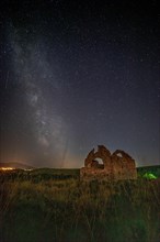 View of a church ruin at night. Above the ruin