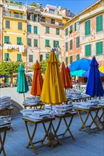 Coloured parasols of a closed restaurant at the main square of Vernazza