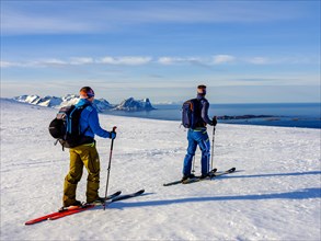 Two ski mountaineers with a view of the sea