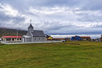 Grey wooden church and dwellings in Bakkagerdi village