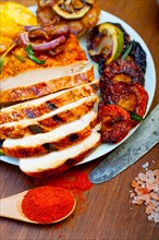 Roasted grilled BBQ chicken breast with herbs and spices rustic style