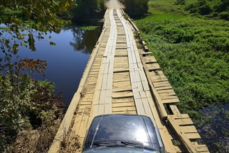Off-road vehicle on a wooden bridge of the Transpantaneira