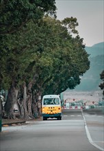 Yellow bus on the street in Macau