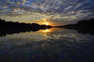 Sunrise with clouds reflected in Rio Sao Lourenco