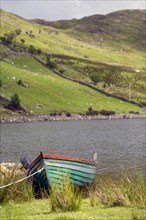Boat tied up at lake side in the West of Ireland. County Galway