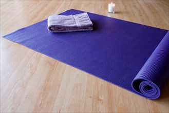 Yoga mat with towel and candle
