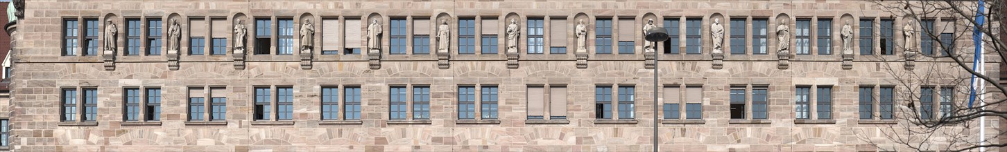 Thirteen stone sculptures of historical jurists on the main facade of the Justice Building