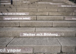 Stairway steps with slogans on the subject of education in several languages