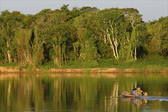 Boat with anglers on the Rio Sao Lourenco in the evening light
