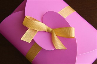 Pink gift box with golden bow