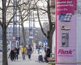 Advertisement of the delivery service Flink on an advertising pillar