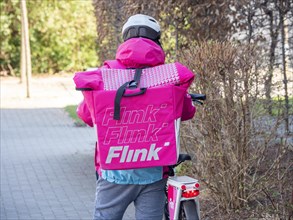 Delivery driver from the delivery service Flink with bicycle