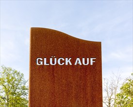 Miner's greeting GLUeCK AUF as lettering in a metal plate in front of the museum