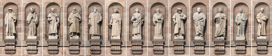 Collage of thirteen stone sculptures of historical legal scholars on the main facade of the Justice Building