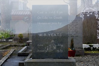 Double exposure of W. B. Yeats gravestone at Drumcliff graveyard underneath Ben Bulben mountain. Sligo