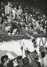 Reich Chancellor Adolf Hitler signs autographs for Canadian athletes in the Artificial Ice Stadium