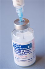 Propofol medical vial with inserted syringe