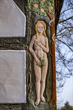 Depiction of Eve on the gable of the Adam and Eve House
