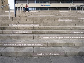 Stairway steps with slogans on the subject of education in several languages
