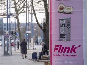 Advertisement of the delivery service Flink on an advertising pillar