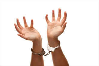 Handcuffed woman desperately raising hands in air isolated on a white background