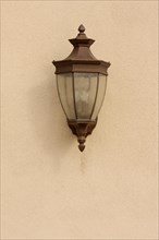 Beautiful lamp on stucco wall