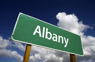 Albany road sign with dramatic blue sky and clouds