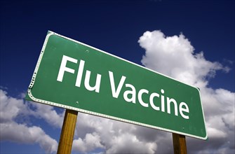 Flu vaccine road sign with dramatic blue sky and clouds
