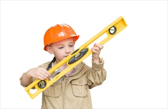 Cute young boy dressed as contractor holding level